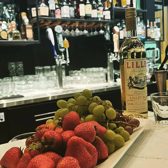 Elegant bar setup with fresh fruits and premium wines