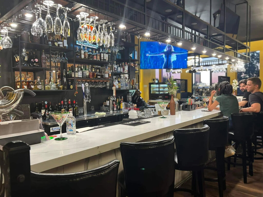 HYE~LIFE restaurant interior showing the vibrant bar atmosphere with guests